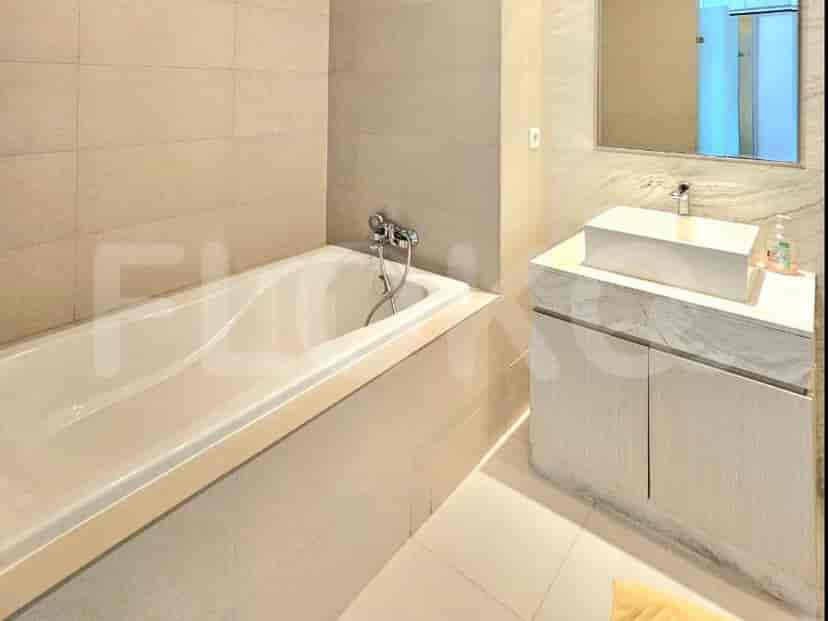 A bathroom with a bathtub, sink, vanity, and mirror.