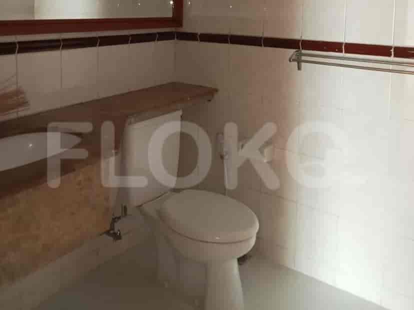 Bathroom with a toilet, sink and mirror.