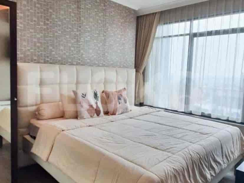 A cozy bedroom with a large bed, soft bedding, and a stylish headboard.