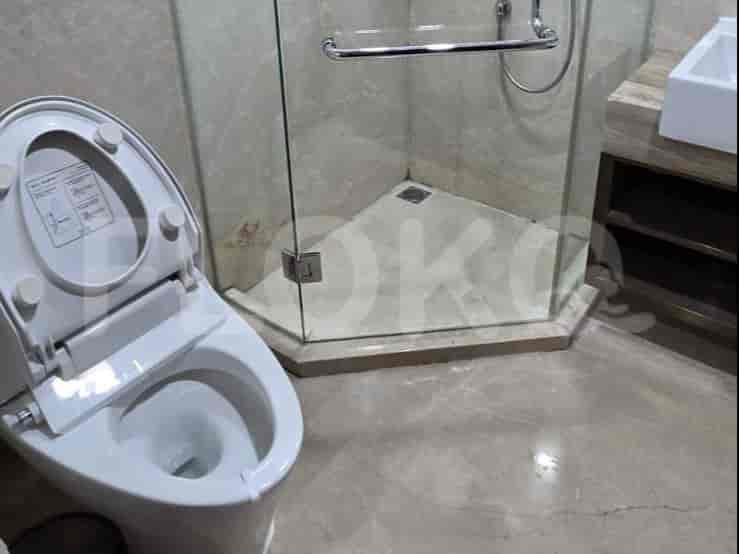 A modern bathroom with a toilet, shower, and elegant design.