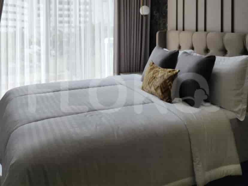 Another view of the bedroom showing the bed with decorative pillows and a view through the window.