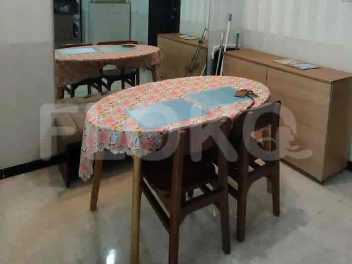 Dining area with a table, chairs, and a mirror.