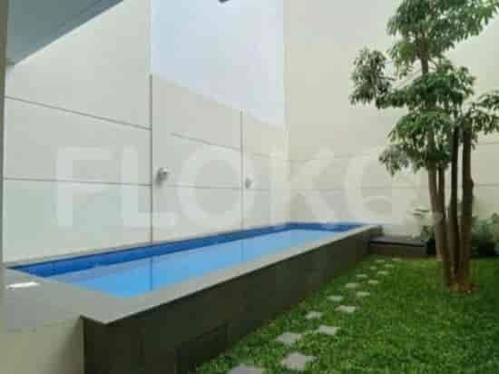 A backyard with a swimming pool and lawn.