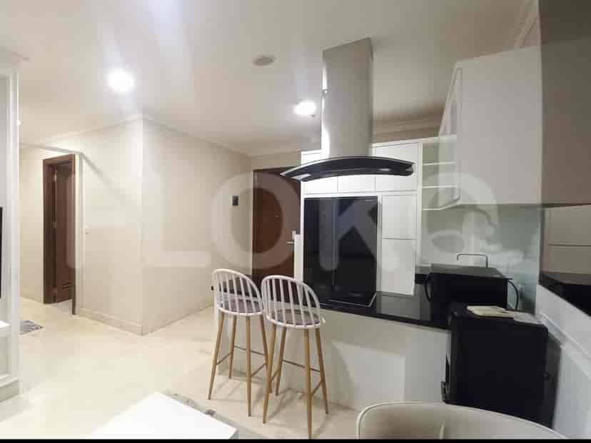 Open concept kitchen and living area with bar stools.