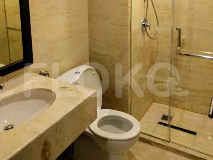 A bathroom with a toilet, sink, and shower.