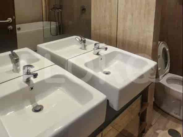 Contemporary bathroom with double sinks, a bathtub, and a mirrored wall.