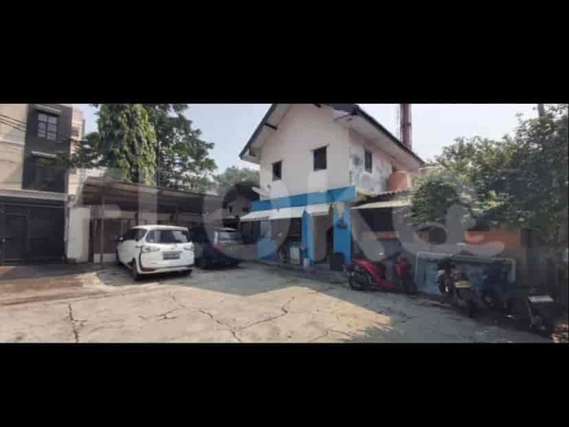 A view of a house from the outside with a parked car and motorcycles.