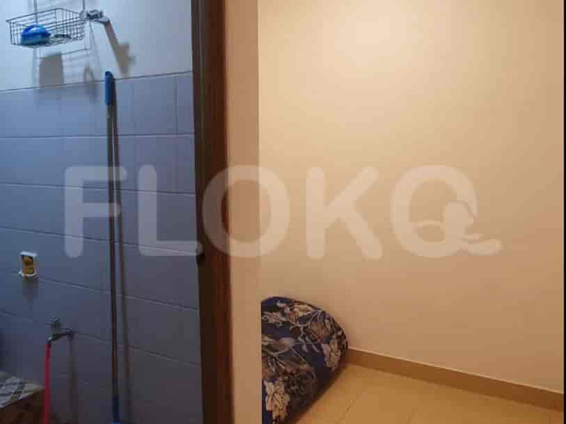 A utility room with laundry and cleaning supplies.
