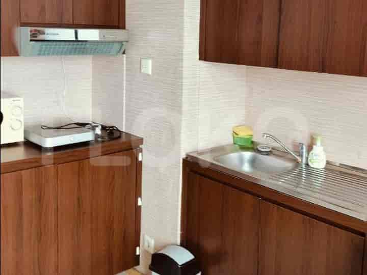 A small kitchen with cabinets, a sink, and appliances.