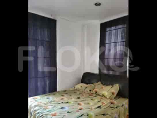 A bedroom with a bed and curtains.