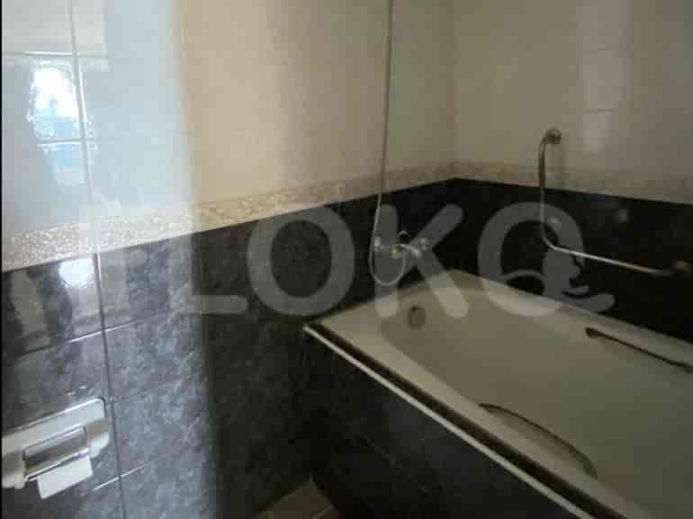 Bathroom with a bathtub and tiled walls.