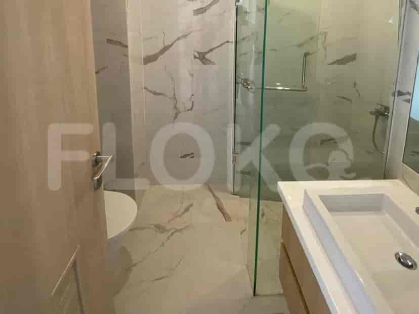 A modern bathroom with a walk-in shower, vanity, and toilet.