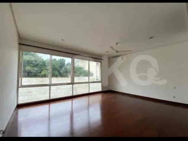 A living room featuring a hardwood floor, large windows, and a modern design aesthetic with a ceiling fan.