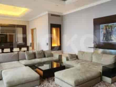 A U-shaped sofa in a large living room with a coffee table and artwork on the wall.