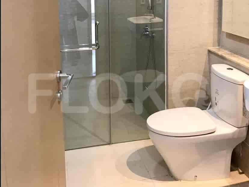 A modern bathroom with a toilet and shower.