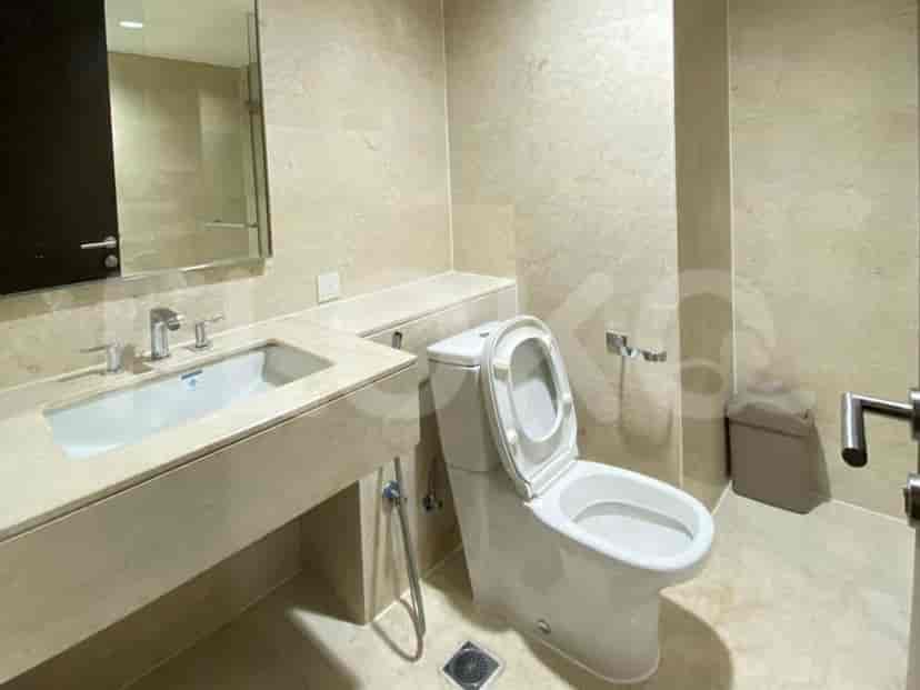 Compact bathroom with a toilet and a vanity.