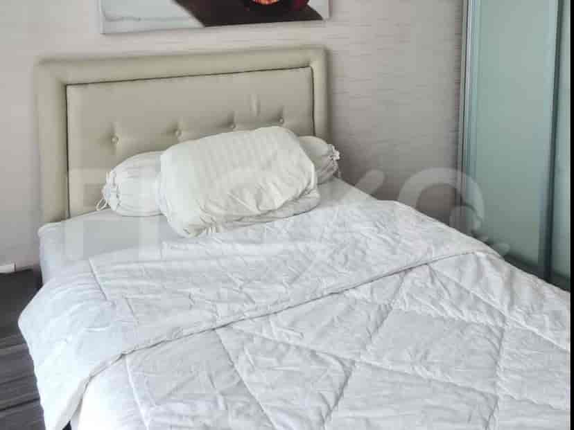 A bedroom with a white bed and contemporary interior design.