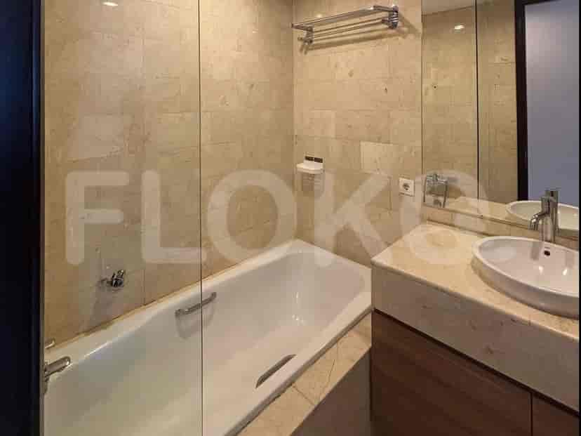 Another view of the bathroom, showcasing a bathtub, vanity, and mirror.