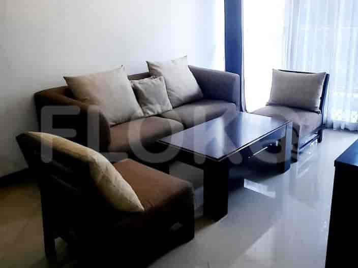 A cozy living room setup with a sofa, two armchairs, a coffee table, and a floor lamp.