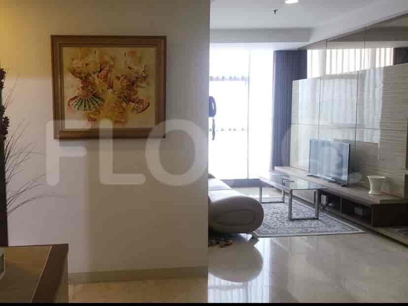 Living room with artwork and a view of the adjoining space.