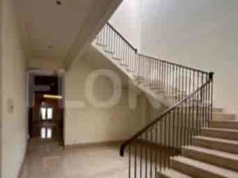 An elegant staircase with marble steps and a black railing.