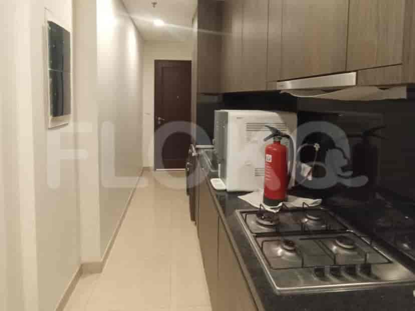 A close-up of a gas stove and fire extinguisher in a kitchen.