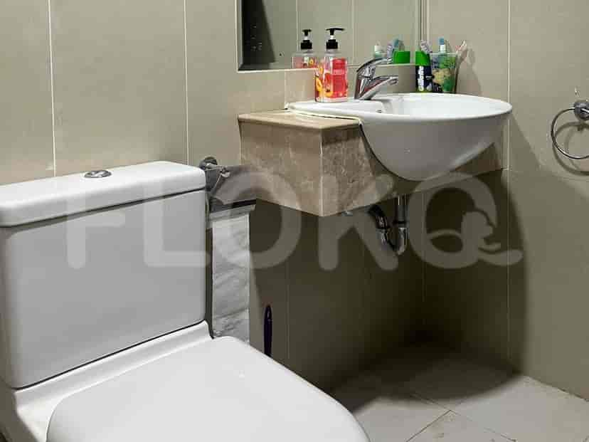 Bathroom with a sink, toilet and mirror.