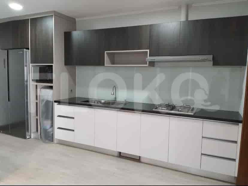 Modern kitchen with dark wood cabinets, white lower cabinets, and stainless steel appliances.