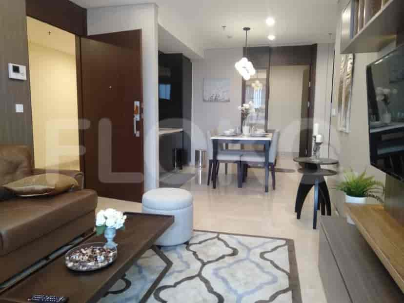 A combined living and dining space featuring a leather sofa, dining table, and modern decor.