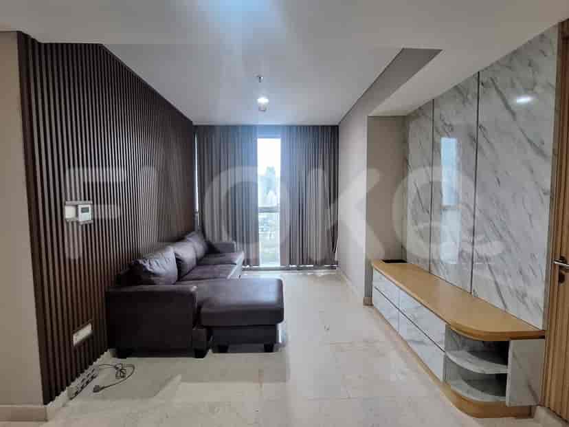 A modern living room with a sectional sofa, marble accent wall, and wooden slatted wall.