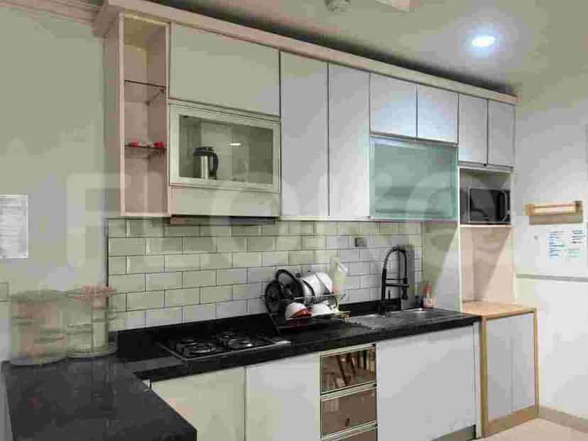 A modern kitchen with white cabinets, a gas stove, and a sink.