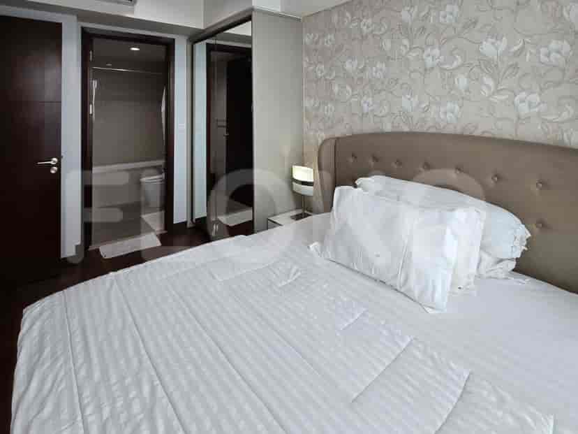 Spacious bedroom with a double bed, bedside table, and mirror.