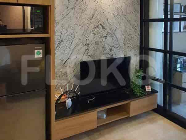 Modern kitchen with built-in appliances and a marble backsplash.