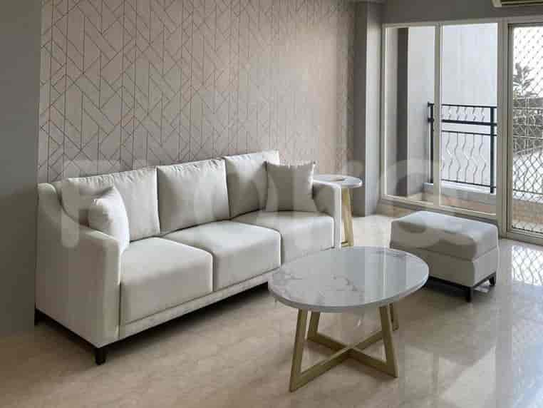 A bright living room featuring a large sofa, coffee table, and small side table.
