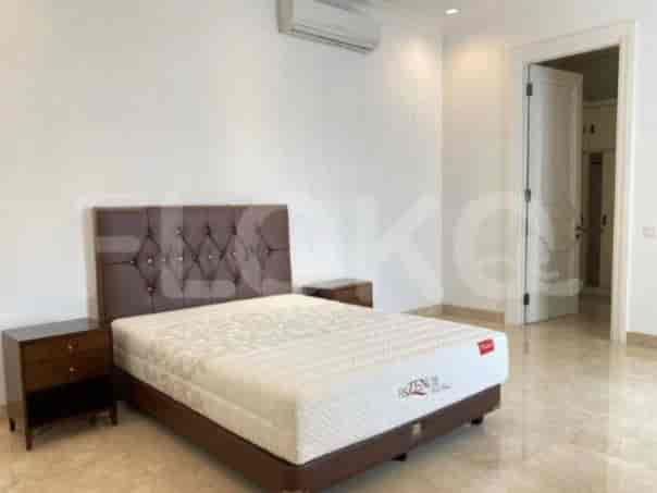 A bedroom with a large bed, nightstands, and a contemporary design.