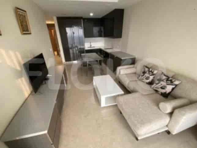 An open-plan living space showcasing the kitchen, dining area, and a comfortable sofa.