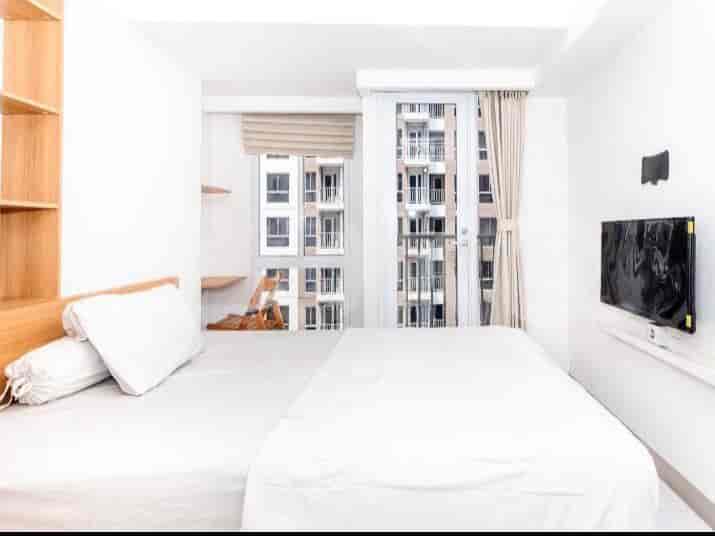 Bedroom with a double bed and a large window offering a city view.