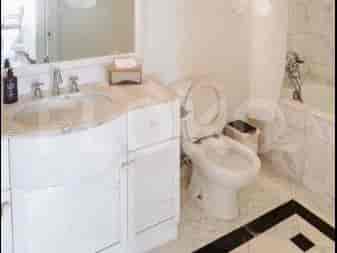 A bathroom with a vanity, toilet, and bathtub.