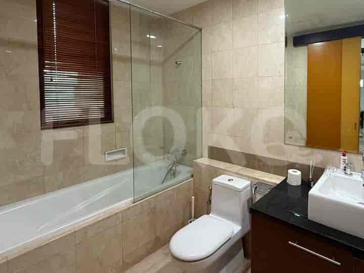 A bathroom with a bathtub, toilet, and sink.