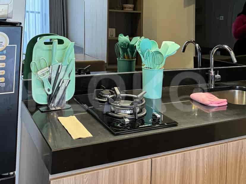 An eye-level view of a modern kitchen featuring wooden cabinets and appliances.