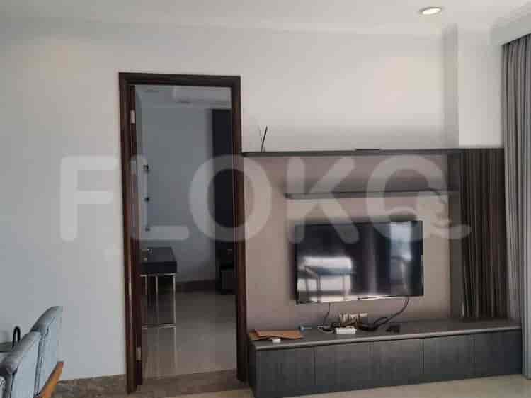 Living room with a TV mounted on a feature wall.