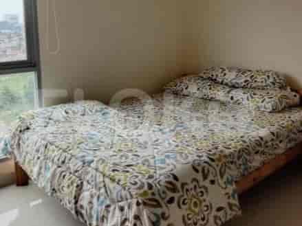 Bedroom with patterned bedding, and a wooden bed frame.