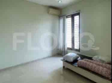 A bedroom with a single bed, air conditioning unit, and a window with blinds.