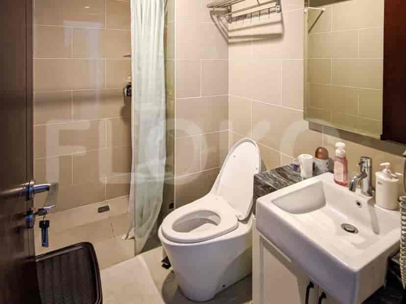 Modern bathroom with toilet, sink, and shower.