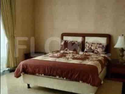 A bedroom with a queen-size bed, nightstands, and a lamp.