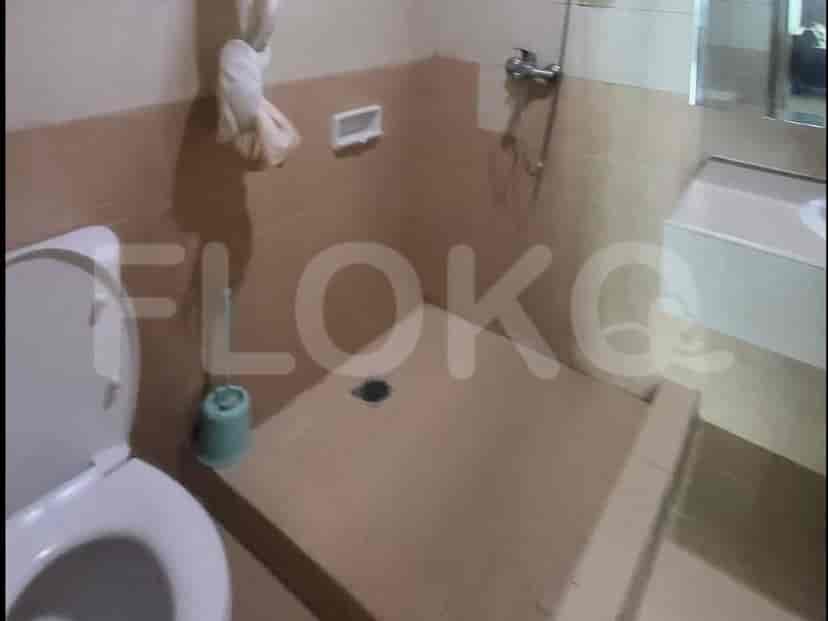 A bathroom with a toilet and a shower area.