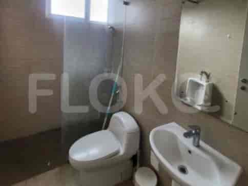 A modern bathroom with a shower, toilet, and sink.