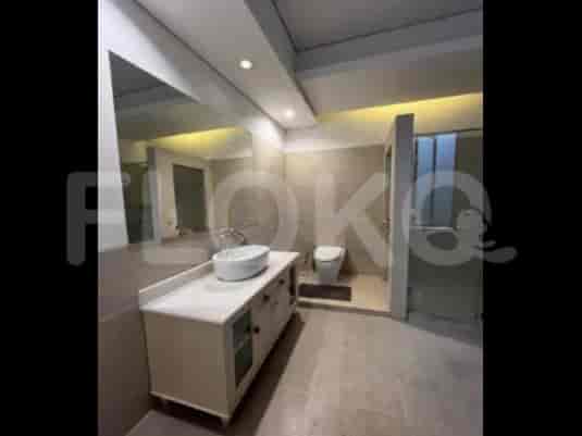 A bathroom featuring a large mirror above the sink, a modern toilet, and a walk-in shower.
