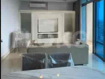 Living room featuring a large sofa, TV, and dining area.