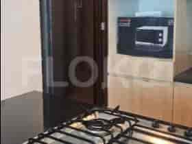 Kitchen space, featuring black countertop and gas stove.